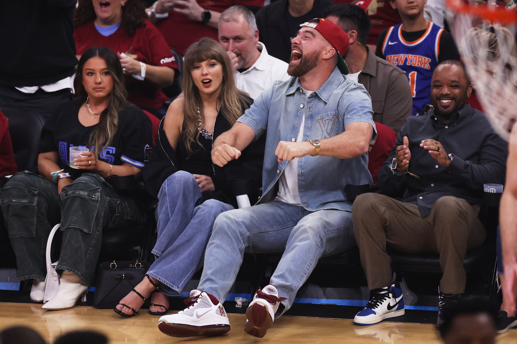 Taylor Swift and Travis Kelce watch the first half of Game 3 in the Eastern Conference finals NBA basketball playoffs series between the New York Knicks and the Cleveland Cavaliers in Cleveland, Saturday, May 23, 2026. (AP Photo/Tim Phillis)