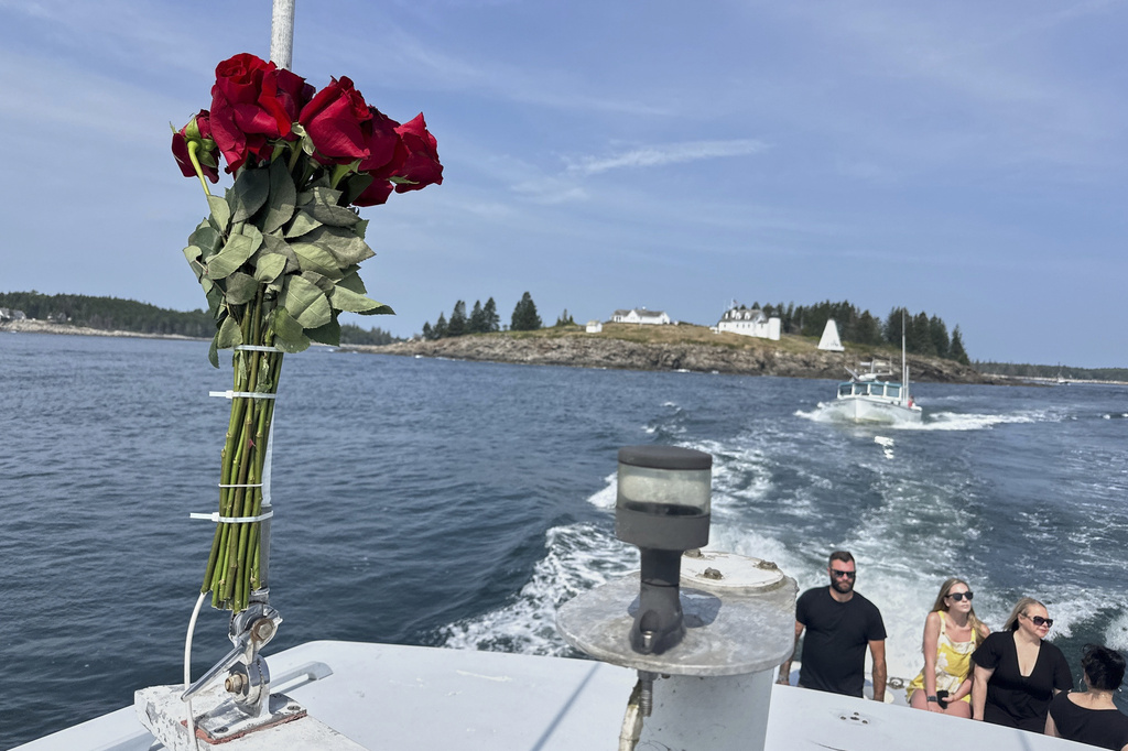 Roses decorate a lobster boat during a memorial service Sunshine Stewart, a former sternman, Sunday, Aug. 10, 2025, off the coast of St. George, Maine. (AP Photo/Robert F. Bukaty)