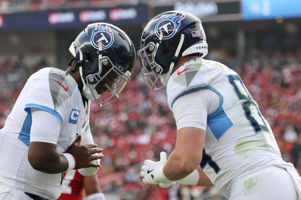 Tennessee Titans quarterback Cam Ward, left, and tight end Gunnar Helm (84) celebrate a touchdown during the first half of an NFL football game against the San Francisco 49ers, Sunday, Dec. 14, 2025, in Santa Clara, Calif. (AP Photo/Jed Jacobsohn)