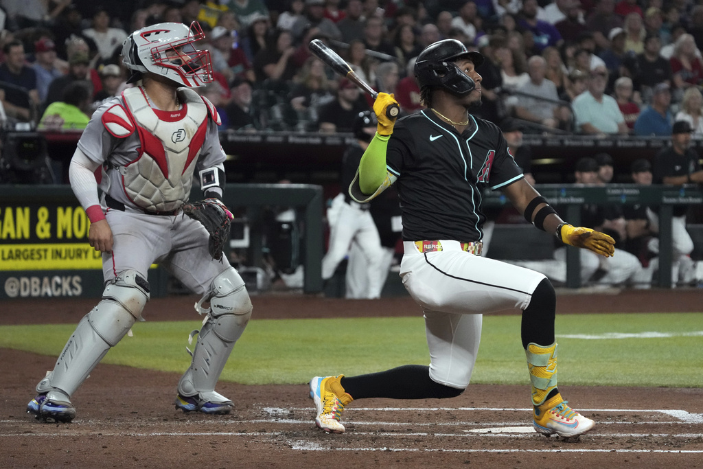 CORRECTS TO SATURDAY INSTEAD OF SUNDAY - Arizona Diamondbacks' Geraldo Perdomo hits an RBI sacrifice fly out against the Boston Red Sox in the second inning of a baseball game, Saturday, Sept 6, 2025, in Phoenix. (AP Photo/Rick Scuteri)