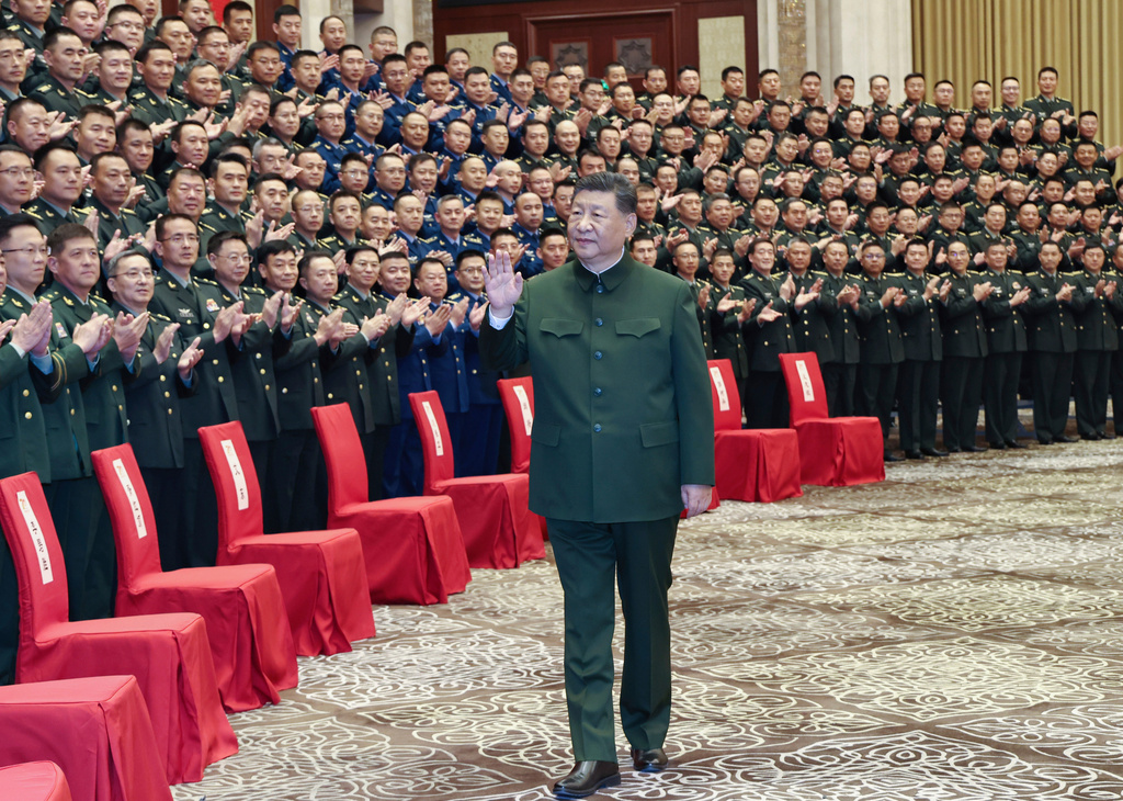 In this photo released by Xinhua News Agency, Chinese President Xi Jinping, also general secretary of the Communist Party of China Central Committee and chairman of the Central Military Commission, meets with representatives of military personnel stationed in Urumqi in northwestern China's Xinjiang Uygur Autonomous Region on Tuesday, Sept. 23, 2025. (Li Gang/Xinhua via AP)