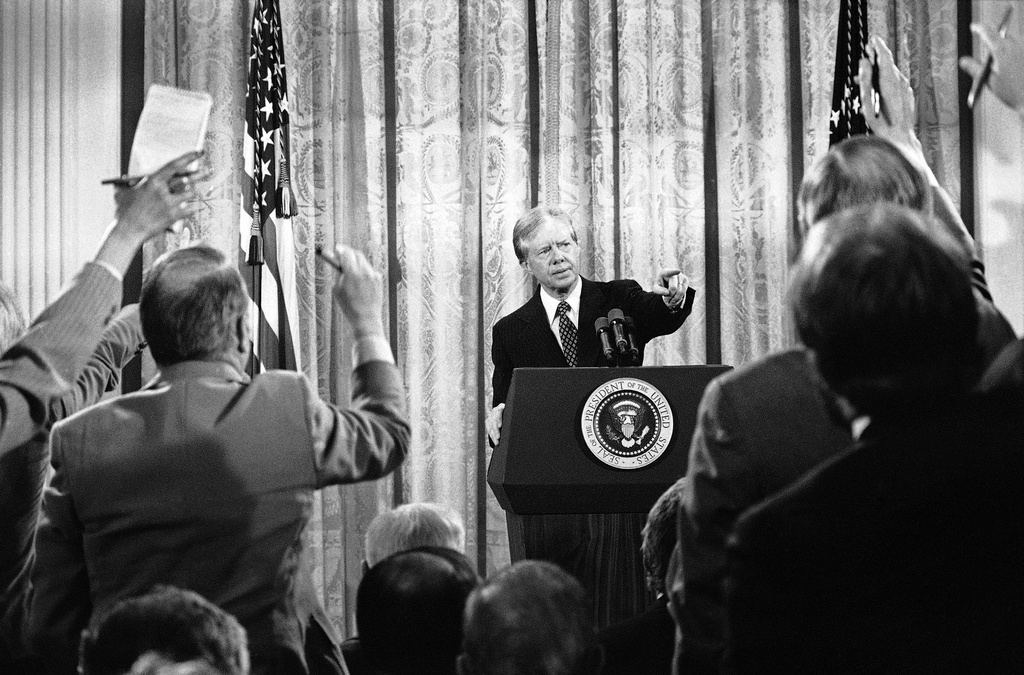 FILE - President Jimmy Carter calls for a question during a nationally televised news conference in the East Room of White House in Washington, April 10, 1980. (AP Photo/Dennis Cook, File)
