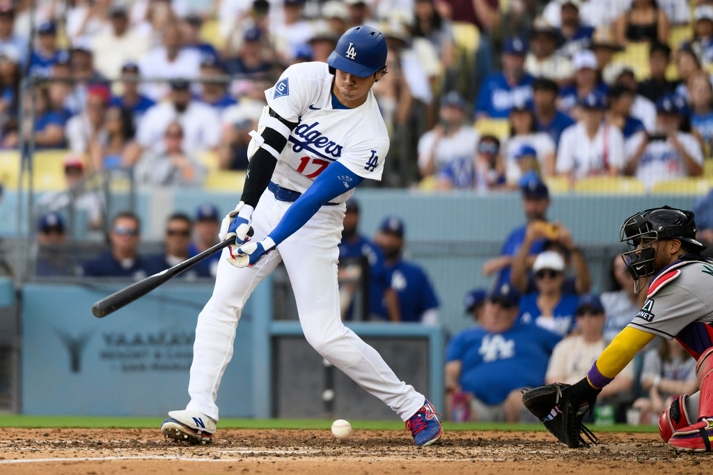 Los Angeles Dodgers' Shohei Ohtani swings and misses for a strikeout during the seventh inning of a baseball game against the Arizona Diamondbacks in Los Angeles, Sunday, July 12, 2026. (AP Photo/Kyusung Gong)
