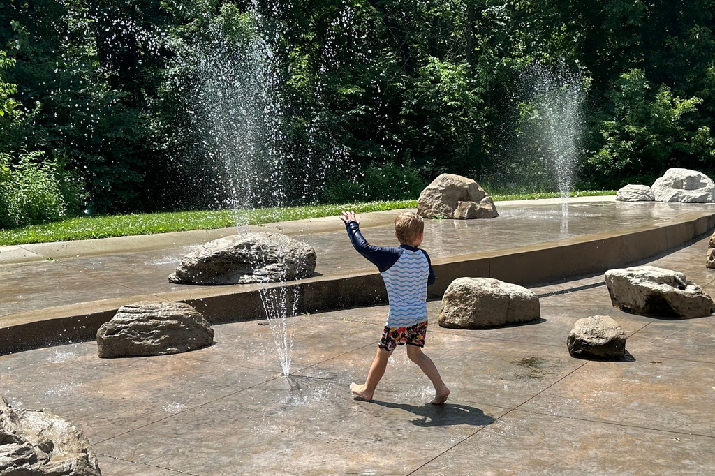 Children play at a water sprayground in Des Moines, Iowa, Monday, June 29, 2026. (AP Photo/Hannah Fingerhut)