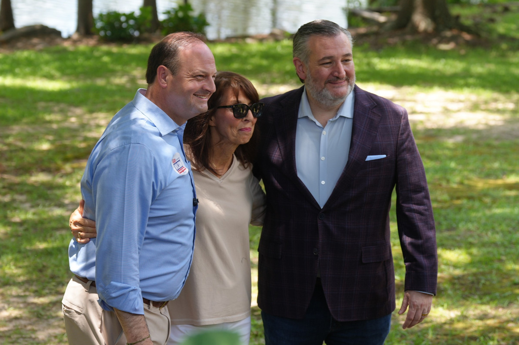 South Carolina Attorney General Alan Wilson, from left, poses for a photo with an attendee and Sen. Ted Cruz, R-Texas, at an ice cream social supporting his gubernatorial campaign ahead of the Republican primary runoff, Monday, June 22, 2026, in Sumter, S.C. (AP Photo/Meg Kinnard)