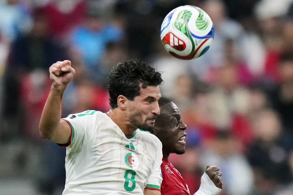 Algeria's Houssem Aouar (8) and Switzerland's Denis Zakaria (6) battle for a head ball during the World Cup round of 32 soccer match between Switzerland and Algeria in Vancouver, British Columbia, Thursday, July 2, 2026. (Darryl Dyck/The Canadian Press via AP)