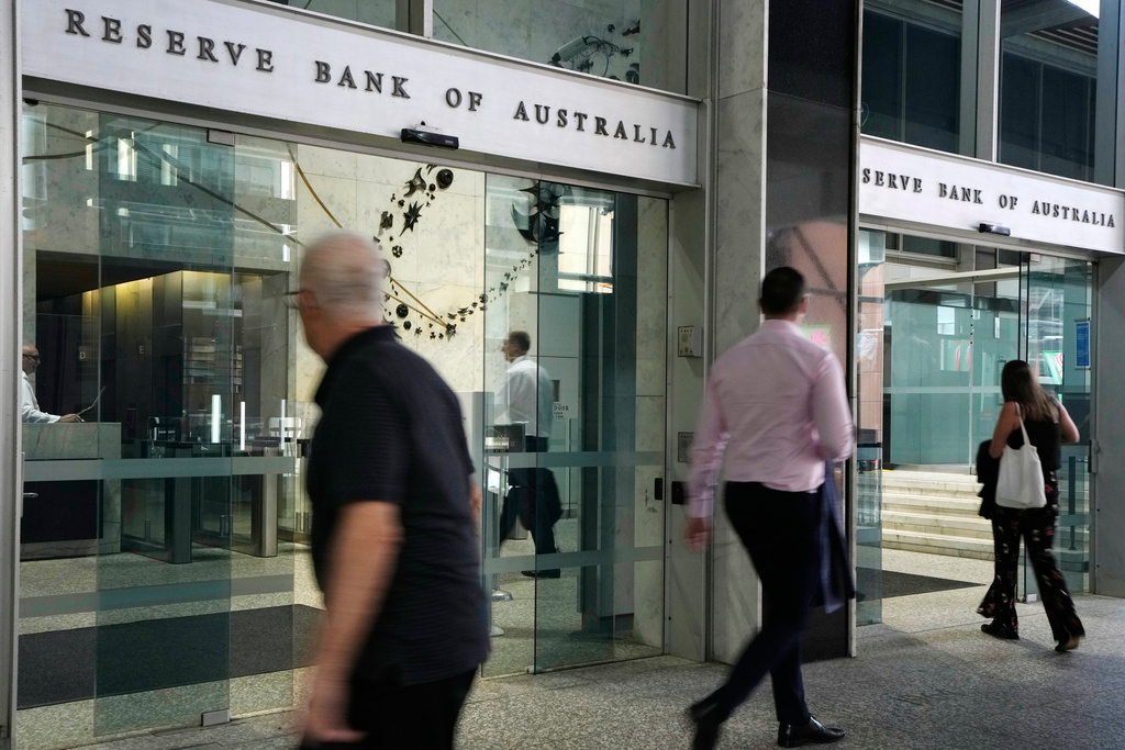 FILE - People arrive at the Reserve Bank of Australia in Sydney, Dec. 6, 2022. (AP Photo/Rick Rycroft, File)