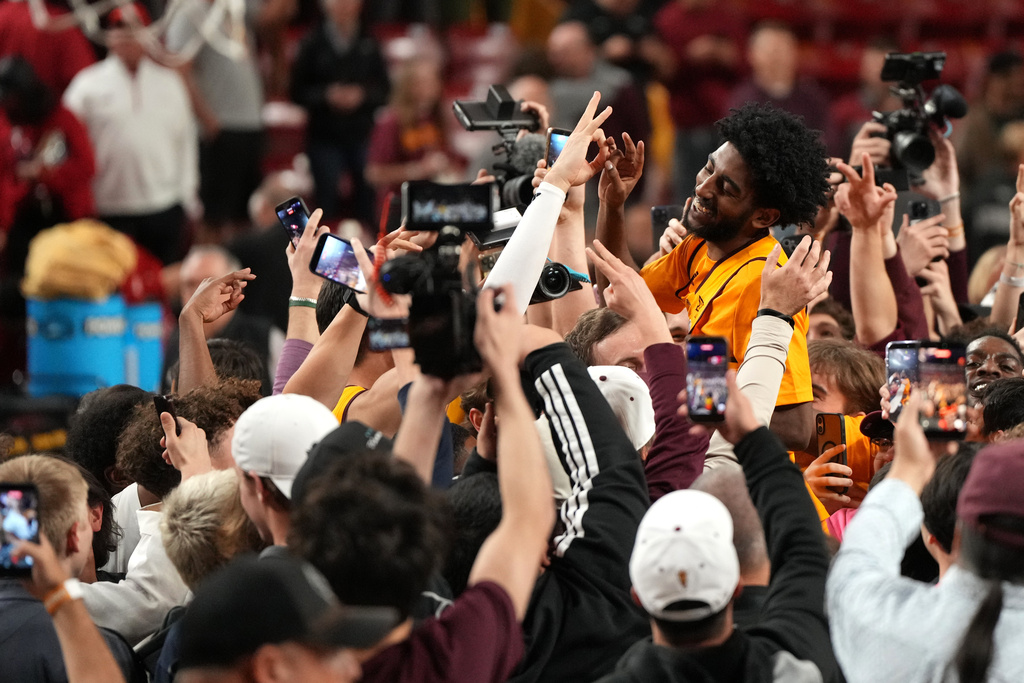 Arizona State guard Maurice Odum celebrates with fans after defeating Texas Tech during an NCAA college basketball game, Tuesday, Feb. 17, 2026, in Tempe, Ariz. (AP Photo/Rick Scuteri)
