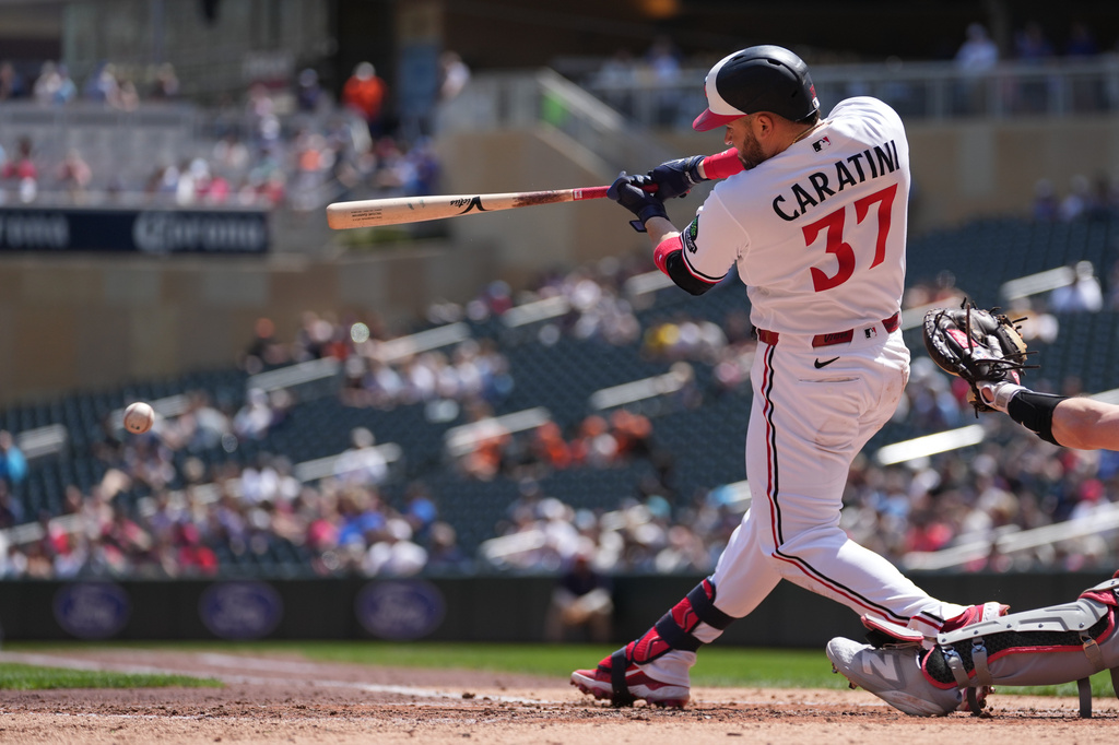 Minnesota Twins' Victor Caratini (37) hits a ground out to second to score Ryan Jeffers during the second inning of a baseball game against the Miami Marlins Thursday, May 14, 2026, in Minneapolis. (AP Photo/Abbie Parr)