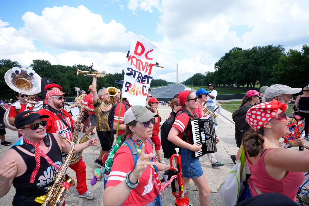 A group of local activist from Washington DC, demonstrating during the March on Washington rally at the Lincoln Memorial on the National Mall, Friday, Aug. 28, 2026 in Washington. (AP Photo/Manuel Balce Ceneta)