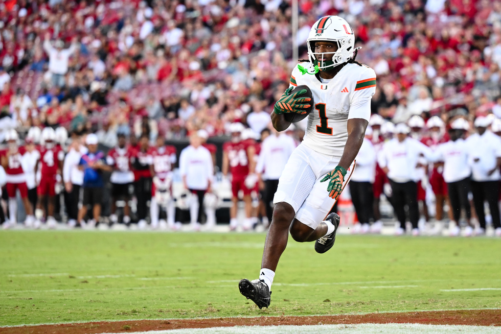Miami wide receiver Malachi Toney (1) scores a touchdown against Stanford during the first half of an NCAA college football game Friday, Sept. 4, 2026, in Stanford, Calif. (AP Photo/Thien-An Troung)