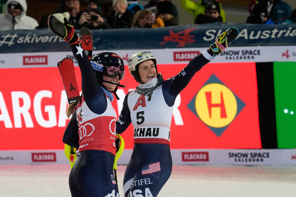 United States' Mikaela Shiffrin, left, poses with United States' Paula Moltzan at the finish line during an alpine ski, women's World Cup slalom, in Flachau, Austria, Tuesday, Jan. 13, 2026. (AP Photo/Giovanni Auletta)