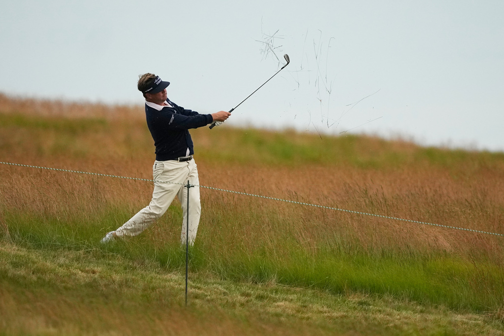 Keith Mitchell hits from the rough on the 13th hole during the first round of the U.S. Open golf tournament at Shinnecock Hills Golf Club in Southampton, N.Y., Thursday, June 18, 2026.(AP Photo/Gerald Herbert)