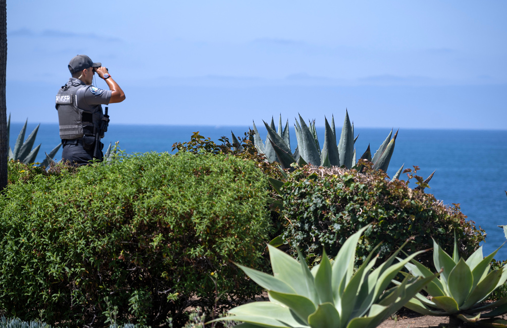 A Park Ranger scans the horizon on Wednesday, June 10, 2026, on Laguna Beach, Calif., near where a child was swept out to sea Tuesday. (Mindy Schauer/The Orange County Register via AP)