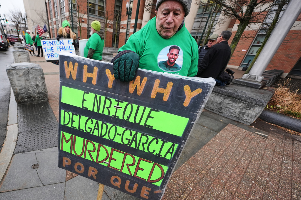 Rod Cleveland, of Middleborough, Mass., a supporter of victim Enrique Delgado-Garcia, pickets outside Worcester County Superior Court where three Mass. State Police officers were arraigned on charges of involuntary manslaughter, Thursday, April 2, 2026, in Worcester, Mass. (AP Photo/Charles Krupa)