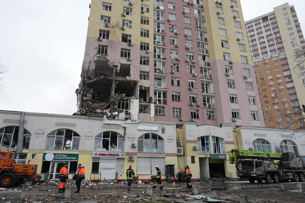 Rescuers work on the scene of a building damaged by a Russian attack in Kyiv, Ukraine, Saturday, Dec. 27, 2025. (AP Photo/Efrem Lukatsky)