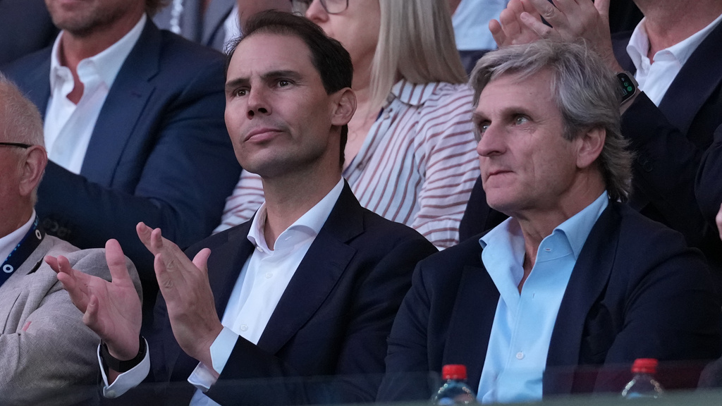 Rafael Nadal, left, and his agent Carlos Costa watch the men's single final between Carlos Alcaraz of Spain and Novak Djokovic of Serbia at the Australian Open tennis championship in Melbourne, Australia, Sunday, Feb. 1, 2026. (AP Photo/Dita Alangkara)
