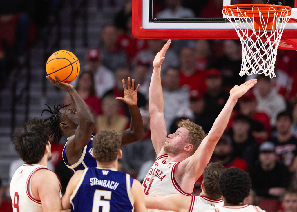 Washington's Zoom Diallo, left, shoots against Nebraska's Rienk Mast (51) during the first half of an NCAA college basketball game Wednesday, Jan. 21, 2026, in Lincoln, Neb. (AP Photo/Rebecca S. Gratz)
