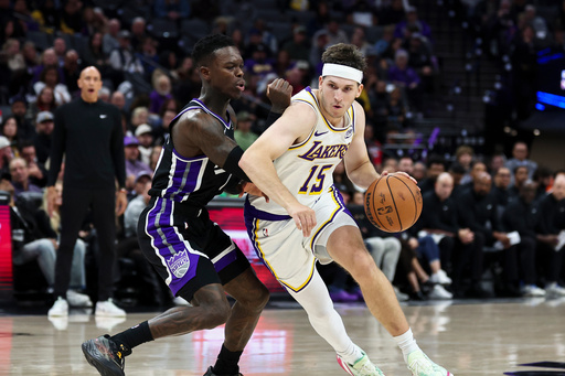 Los Angeles Lakers guard Austin Reaves (15) drives to the basket with Sacramento Kings guard Dennis Schröder, left, defending during the second half of an NBA basketball game Sunday, Oct. 26, 2025, in Sacramento, Calif. (AP Photo/Sara Nevis) Los Angeles Lakers guard Austin Reaves (15) drives to the basket with Sacramento Kings guard Dennis Schröder, left, defending during the second half of an NBA basketball game Sunday, Oct. 26, 2025, in Sacramento, Calif. (AP Photo/Sara Nevis)