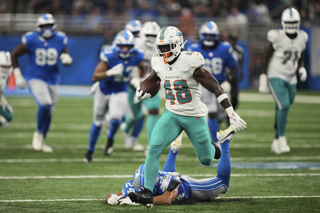 Miami Dolphins running back Jacob Saylors (48) carries against Detroit Lions cornerback Cam Smith (24) during the second half of an NFL preseason football game Saturday, Aug. 16, 2025, in Detroit. (AP Photo/Paul Sancya)