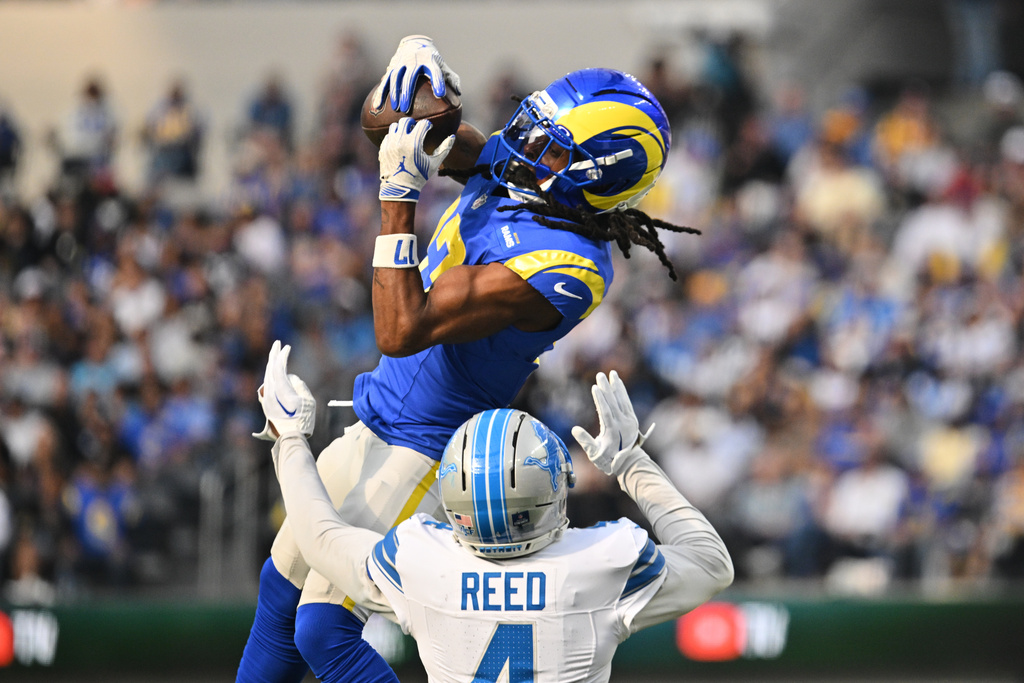 Los Angeles Rams wide receiver Davante Adams (17) makes a catch over Detroit Lions cornerback D.J. Reed (4) during the first half of an NFL football game Sunday, Dec. 14, 2025, in Inglewood, Calif. (AP Photo/Katie Chin)