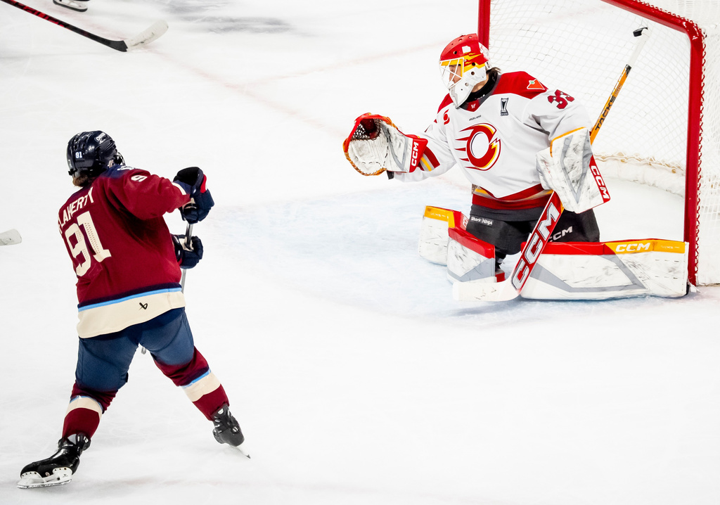 Montreal Victoire's Maggie Flaherty (91) scores past Ottawa Charge goaltender Gwyneth Philips (33) during overtime in Game 2 of the PWHL Walter Cup finals hockey series in Laval, Quebec, Saturday, May 16, 2026.(Christopher Katsarov/The Canadian Press via AP)