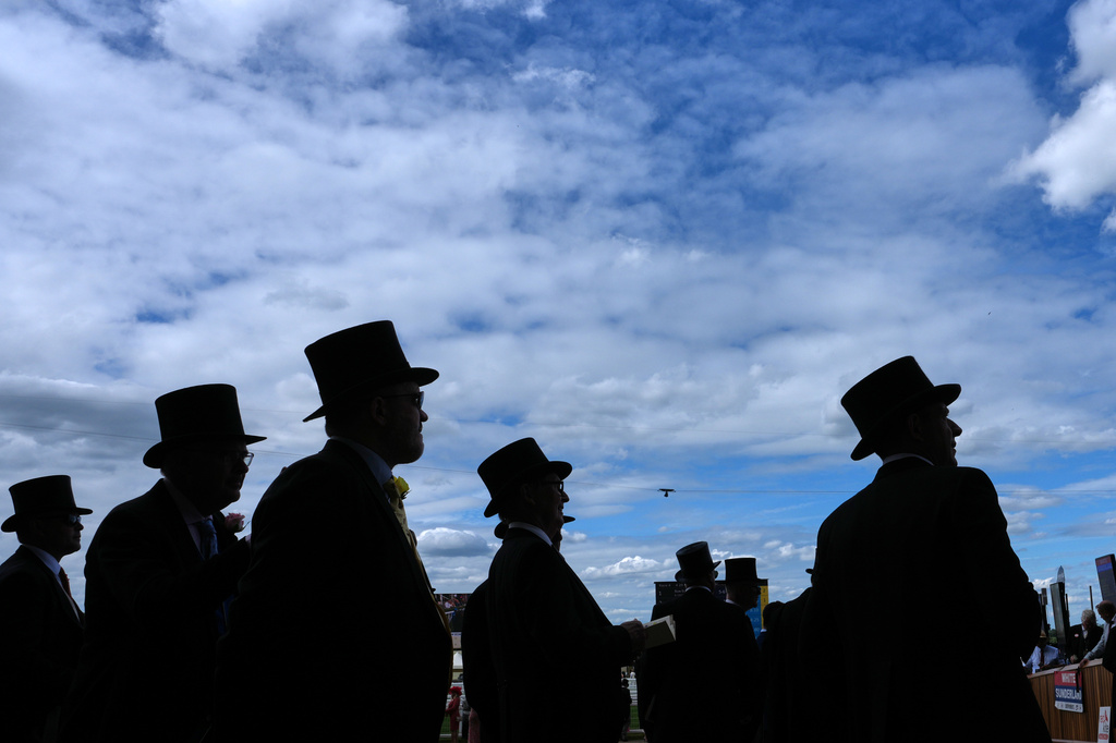 Racegoers are silhouetted as they follow the action on the first day of the Royal Ascot horse race meeting in Ascot, England, Tuesday, June 16, 2026.(AP Photo/Kin Cheung)