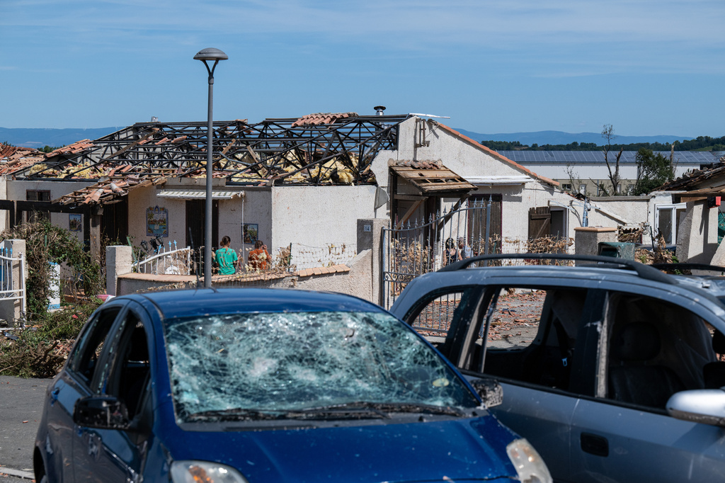 Cars and a damaged house are pictured after a tornado ravaged the small village of Pomas in southern France, leaving dozens injured, Tuesday Aug. 25, 2026. (AP Photo/Frederic Lancelot)