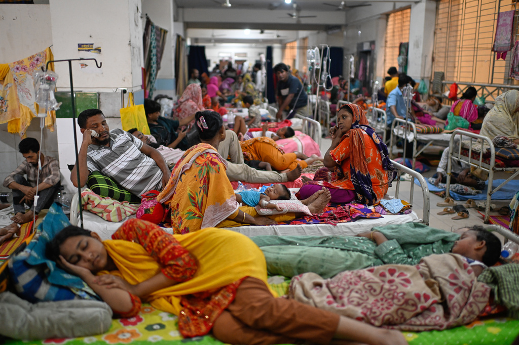 Patients receive treatment during a measles outbreak as family members sit beside them in an overcrowded hospital in Dhaka, Bangladesh, Tuesday, Sept. 8, 2026. (AP Photo/Mahmud Hossain Opu)