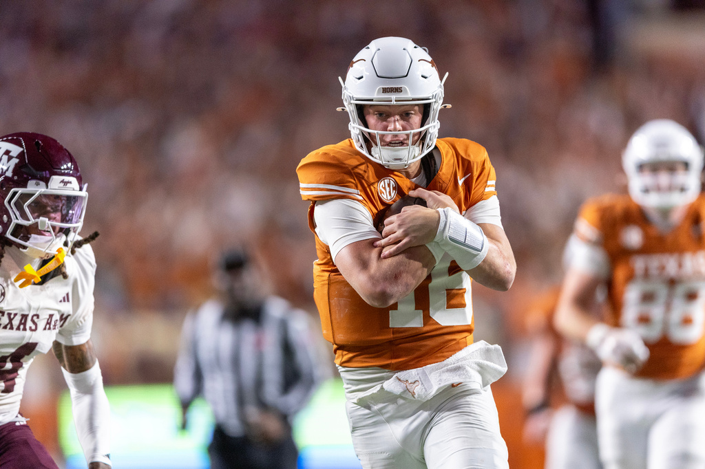 FILE - Texas quarterback Arch Manning (16) scores a touchdown past Texas A&M cornerback Will Lee III (4) during the second half of an NCAA college football game Friday, Nov. 28, 2025, in Austin, Texas. (AP Photo/Stephen Spillman, File)
