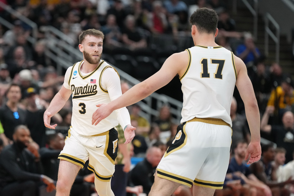 Purdue's Braden Smith (3) is congratulated by teammate Omer Mayer (17) after making a 3-point basket during the first half in the first round of the NCAA college basketball tournament against Queens University, Friday, March 20, 2026, in St. Louis. (AP Photo/Jeff Roberson)