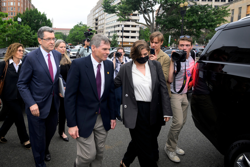 Former Olympic canoeist David Hearn, center, and his attorney Norman Eisen, left, walk to a car following a court appearance, where he pleaded not guilty to allegedly damaging the Lincoln Memorial Reflecting Pool, Thursday, July 9, 2026, in Washington. (AP Photo/Rod Lamkey, Jr.)