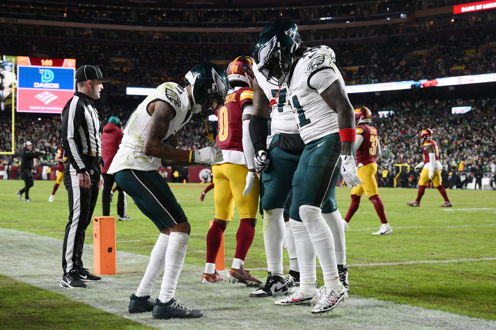 Philadelphia Eagles wide receiver Devonta Smith, front left, celebrates with teammates after his touchdown against the Washington Commanders during the first half of an NFL football game, Thursday, Dec. 20, 2025, in Landover, Md. (AP Photo/Nick Wass)
