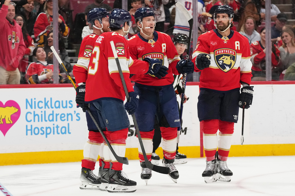 Florida Panthers left wing Matthew Tkachuk, second from right, reacts after scoring a goal during the second period of an NHL hockey game against the Ottawa Senators, Tuesday, March 31, 2026, in Sunrise, Fla. (AP Photo/Lynne Sladky)