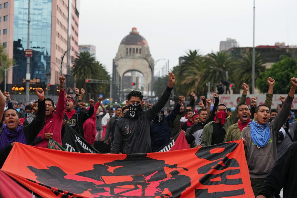 Demonstrators march to mark the 11th anniversary of the disappearance of 43 students from the Ayotzinapa Rural Teachers' College, in Mexico City, Friday, Sept. 26, 2025. (AP Photo/Fernando Llano)