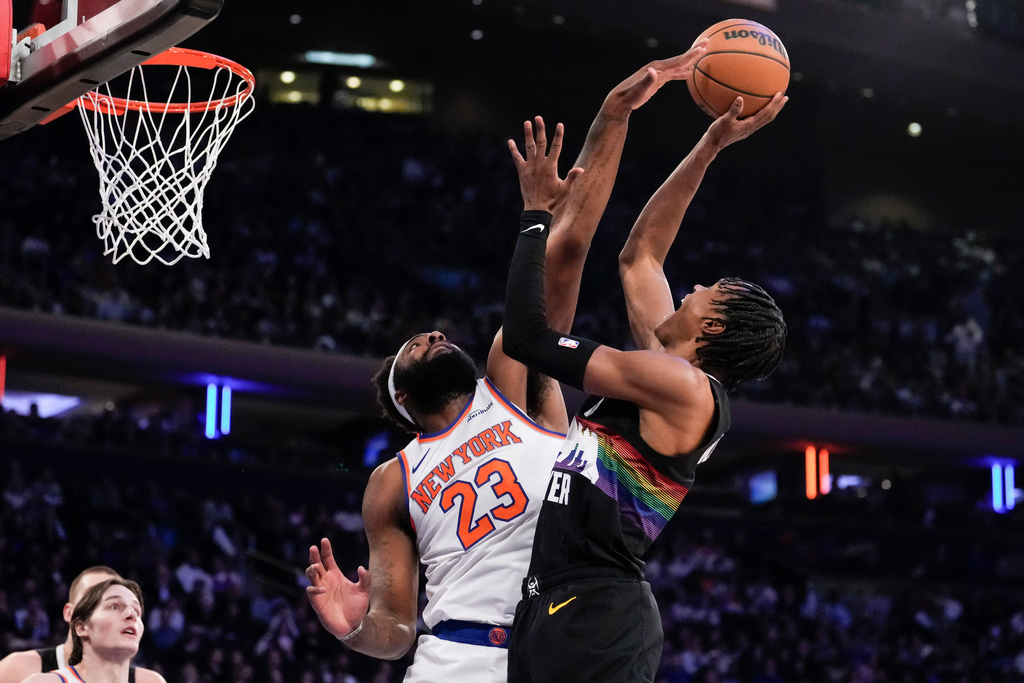 New York Knicks center Mitchell Robinson (23) and Denver Nuggets guard Peyton Watson (8) during the first half of an NBA basketball game, Wednesday, Feb. 4, 2026, in New York. (AP Photo/Yuki Iwamura)