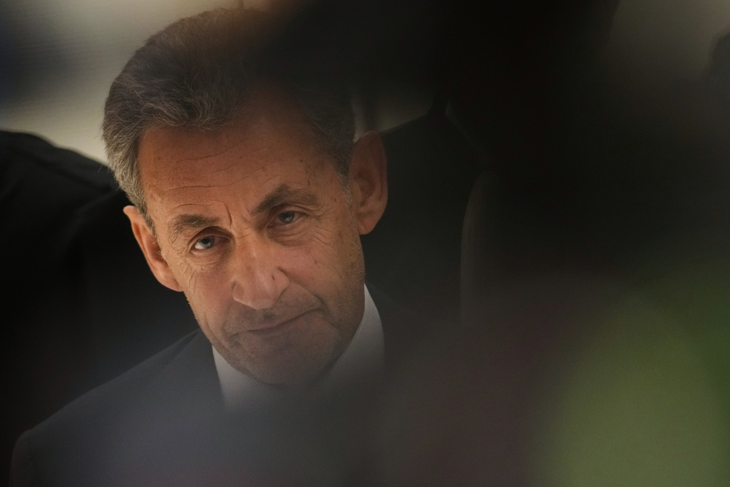 Former French President Nicolas Sarkozy pauses as he speaks with the media after a Paris court sentenced him to 5 years after finding him guilty of criminal conspiracy in an alleged scheme to finance his 2007 campaign with funds from Libya, Thursday, Sept. 25, 2025 in Paris. (AP Photo/Christophe Ena)