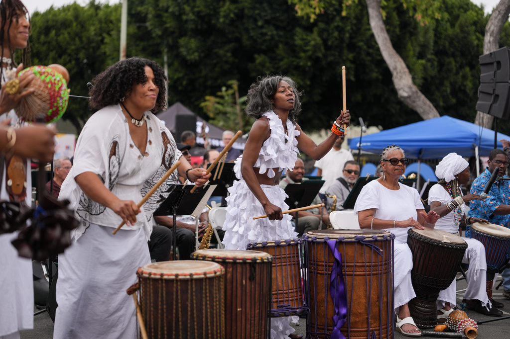 Members of the SHINE Muwasi women's African drum circle perform during a Juneteenth celebration in the Leimert Park neighborhood of Los Angeles, Friday, June 19, 2026. (AP Photo/Jae C. Hong)