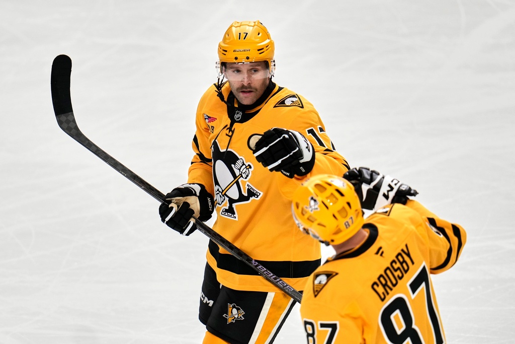 Pittsburgh Penguins' Bryan Rust (17) celebrates with Sidney Crosby after scoring during the third period of an NHL hockey game against the Washington Capitals in Pittsburgh, Thursday, Nov. 6, 2025. (AP Photo/Gene J. Puskar)