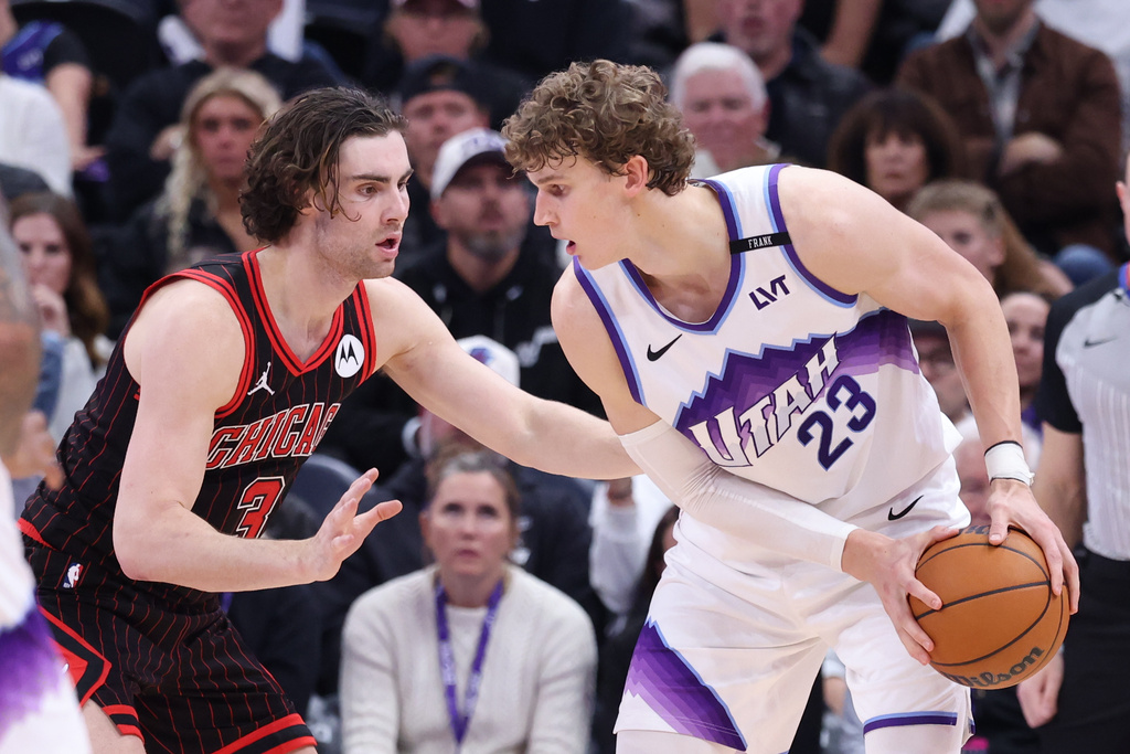 Utah Jazz forward Lauri Markkanen (23) looks to move the ball against Chicago Bulls guard Josh Giddey during the second overtime of an NBA basketball game, Sunday, Nov. 16, 2025, in Salt Lake City. (AP Photo/Rob Gray)