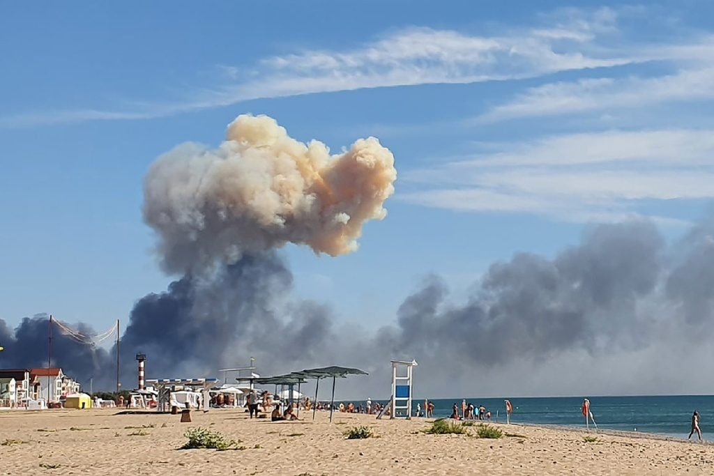 FILE - Rising smoke can be seen from the beach at Saky after explosions were heard from the direction of a Russian military airbase near Novofedorivka, Crimea, Aug. 9, 2022. (AP Photo, File)