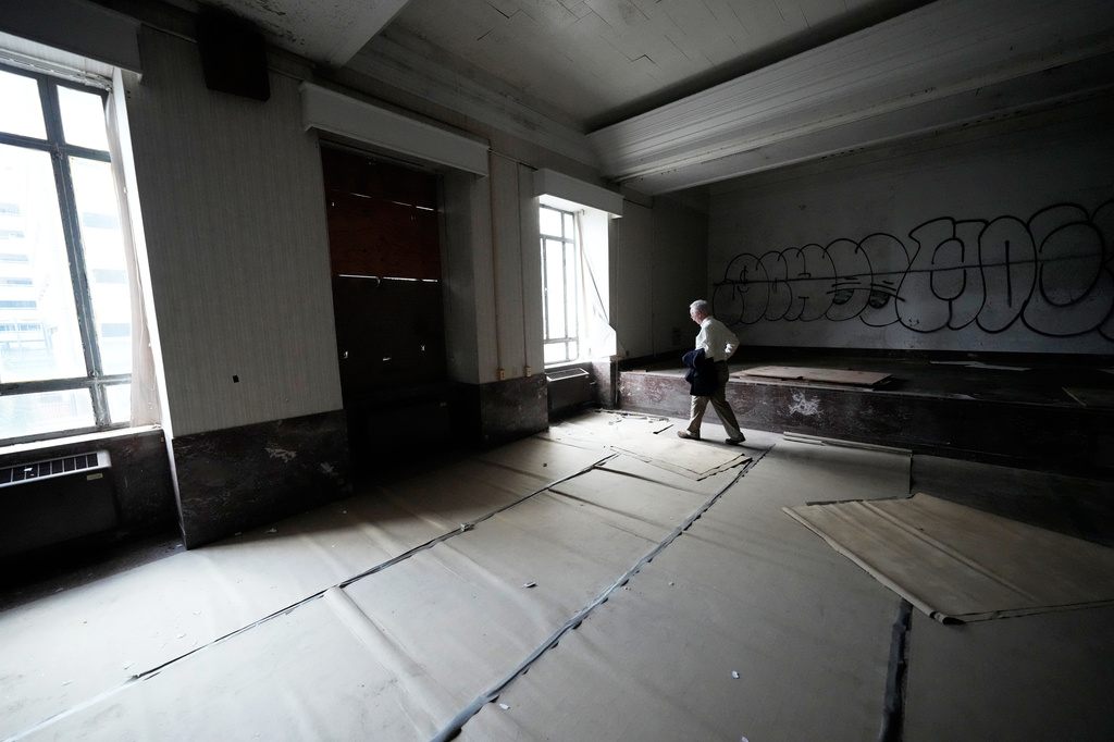Dr. Lee Hamm, dean of the Tulane University School of Medicine, walks in the white coat room of the old Charity Hospital building Wednesday, Aug. 19, 2026, in New Orleans. (AP Photo/Gerald Herbert)