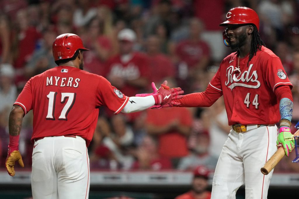 Cincinnati Reds' Dane Myers (17) celebrates hitting a solo home run with Elly De La Cruz (44) during the fifth inning of a baseball game against the Los Angeles Dodgers, Wednesday, Sept. 16, 2026, in Cincinnati. (AP Photo/Carolyn Kaster)