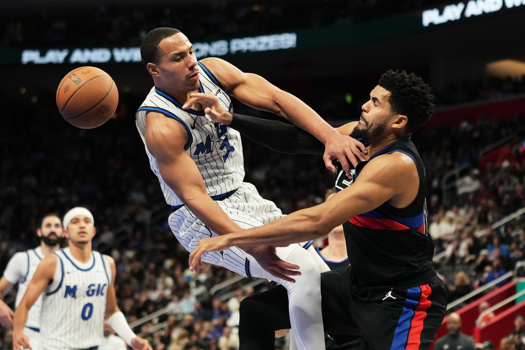 Orlando Magic guard Desmond Bane, left, is fouled by Detroit Pistons forward Tobias Harris during the first half of an NBA Cup basketball game, Friday, Nov. 28, 2025, in Detroit. (AP Photo/Ryan Sun)