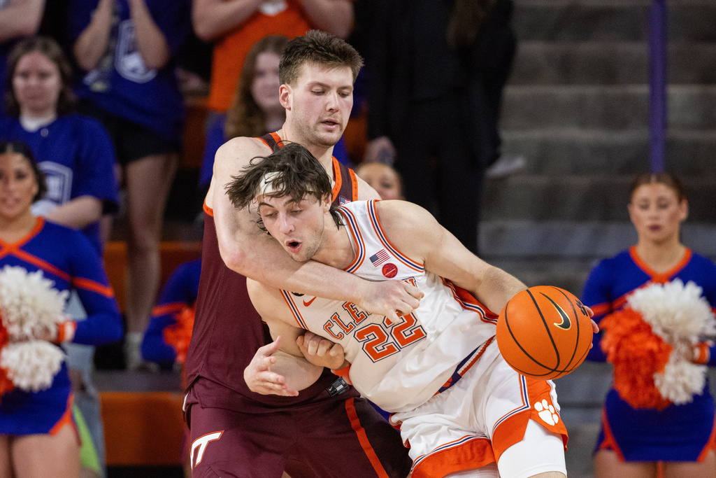 Clemson center Carter Welling (22) posts up against Virginia Tech center Christian Gurdak (32) during the first half of an NCAA college basketball game Wednesday, Feb. 11, 2026, in Clemson, S.C. (AP Photo/Scott Kinser)