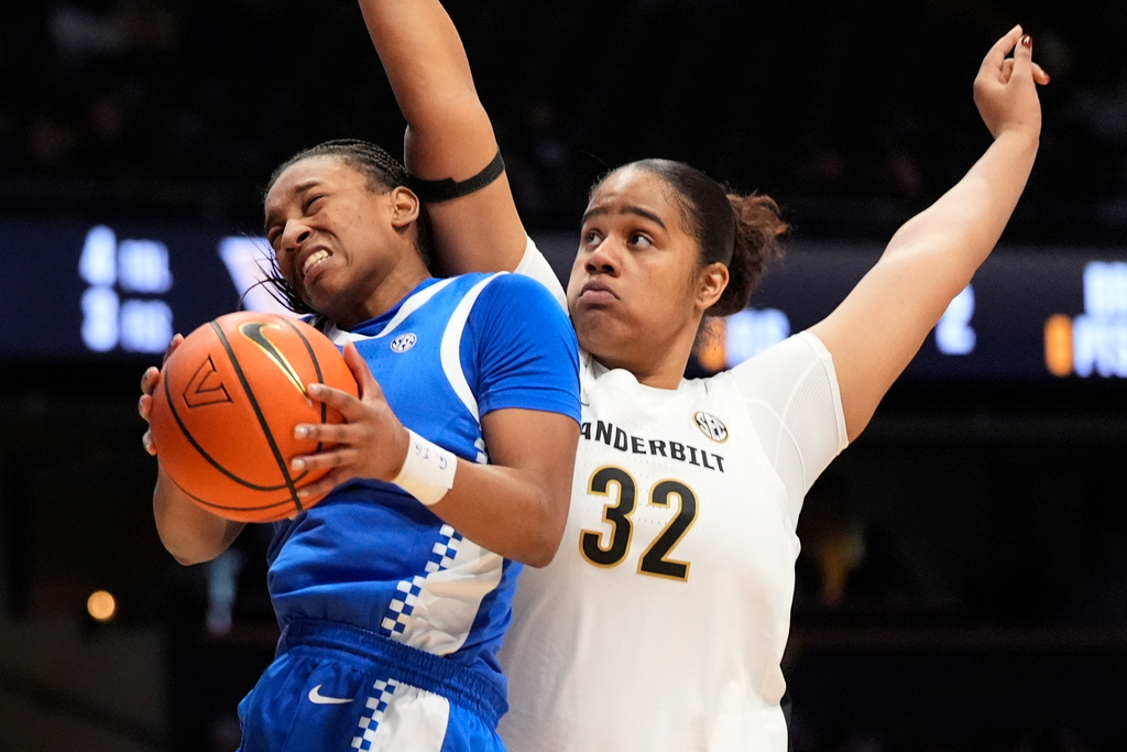Kentucky guard Tonie Morgan, left, shoots the ball past Vanderbilt center Aalyah del Rosario (32) during the first half of an NCAA college basketball game Sunday, Feb. 22, 2026, in Nashville, Tenn. (AP Photo/George Walker IV)