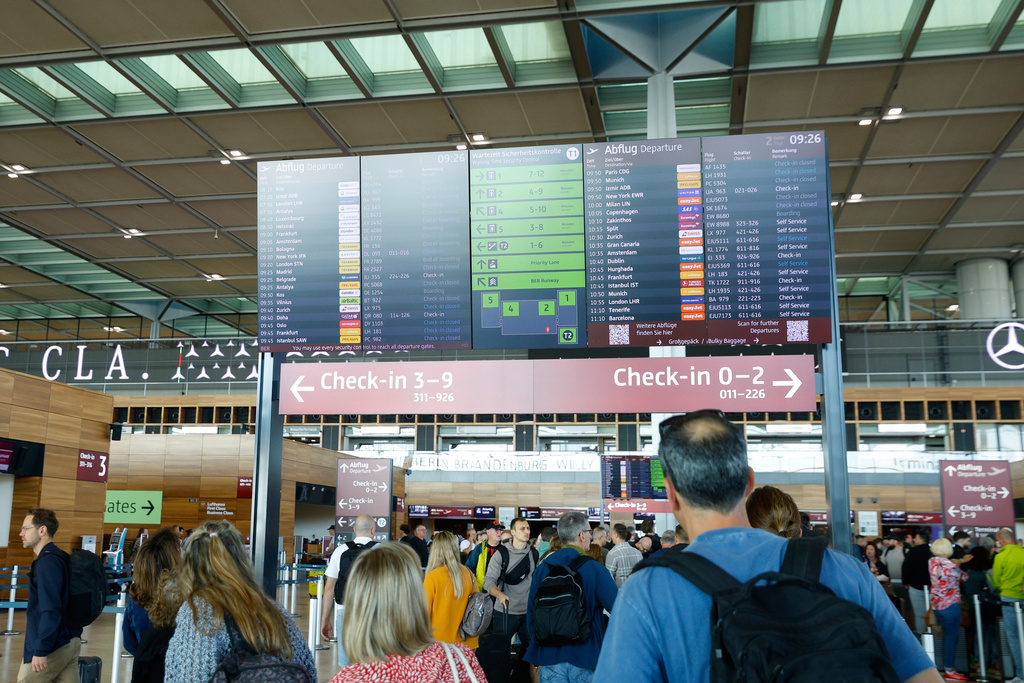 People at BER airport as a cyber attack has caused delays, in Berlin, Germany, Saturday, Sept. 20, 2025. (Carsten Koall/dpa via AP)