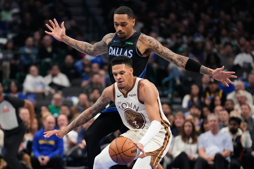 Golden State Warriors guard Will Richard (3) takes control of the ball under pressure from Dallas Mavericks forward P.J. Washington (25) in the first half of an NBA basketball game in Dallas, Thursday, Jan. 22, 2026. (AP Photo/Tony Gutierrez)