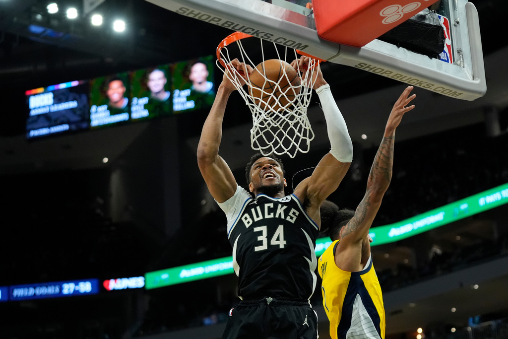 Milwaukee Bucks' Giannis Antetokounmpo (34) dunks past Indiana Pacers' Obi Toppin during the second half of an NBA basketball game, Sunday, March 15, 2026, in Milwaukee. (AP Photo/Aaron Gash)
