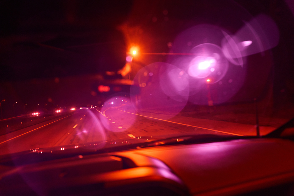 Alek Schott drives past the infrared beam of an automatic license plate reader recording vehicles along Interstate 10, a route he occasionally takes for work trips, near Seguin, Texas, Oct. 15, 2025. (AP Photo/David Goldman)